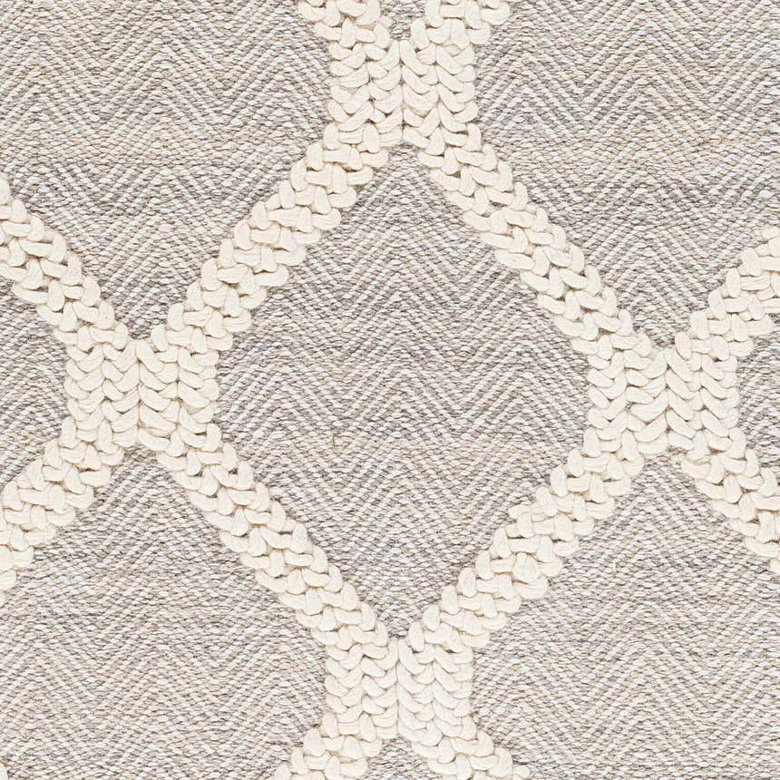 Close-up of the Adora Area Rug. Hand-woven geometric design in bone white against a cloud gray herringbone pattern. Swatch