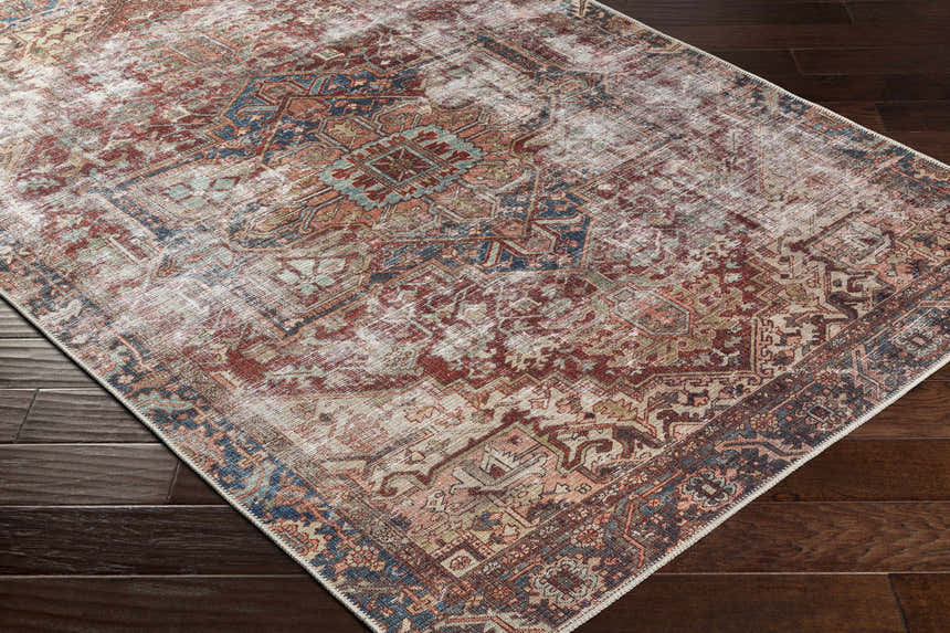 Close-up of the Adtugan Vintage Flat Pile Washable Rug. Features burgundy, gray, and navy tones in a traditional, distressed pattern. Corner