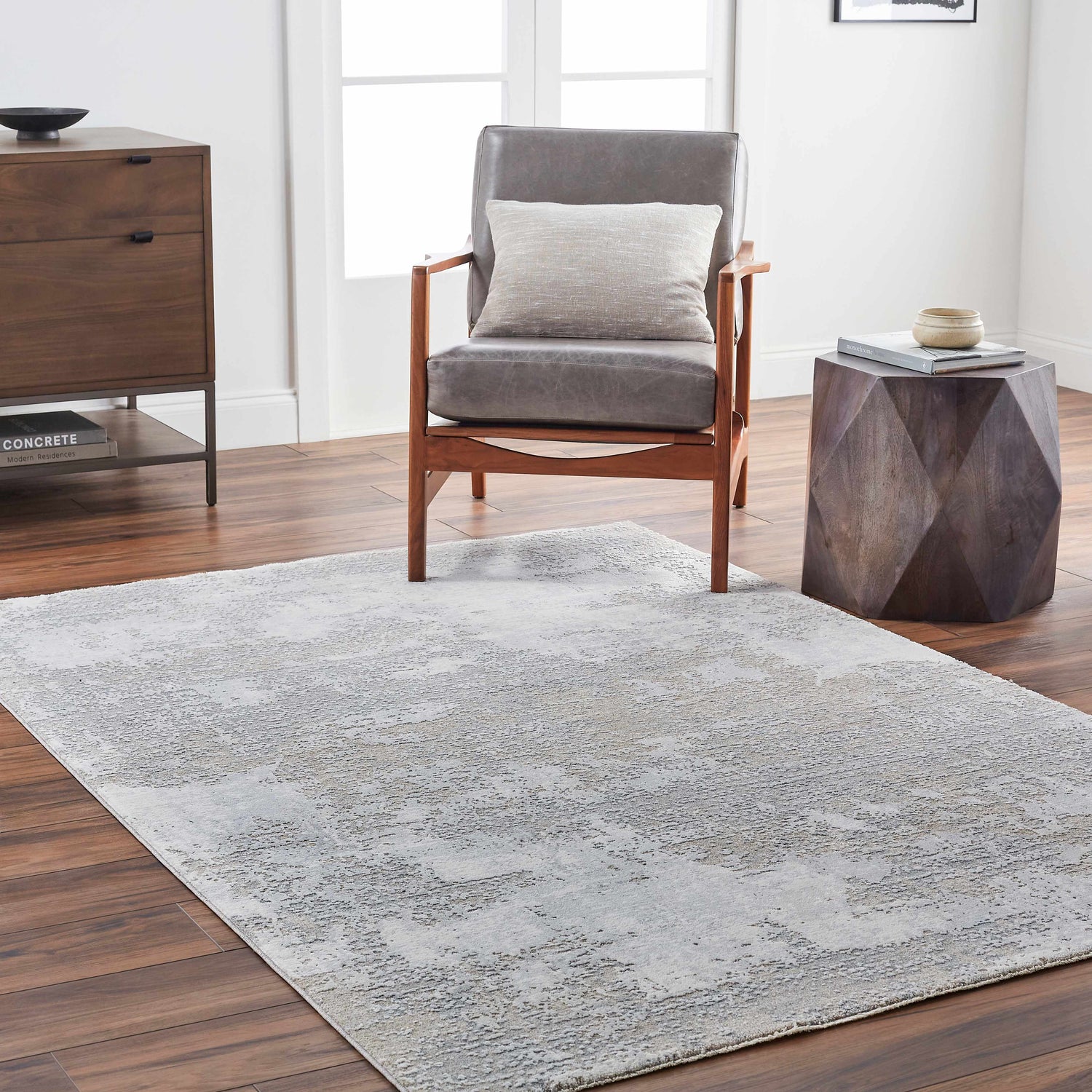 Living room scene with a gray Adwoa Boutique Rug, gray chair, wood accents, and modern decor for a contemporary feel. Roomscene-Rectangle