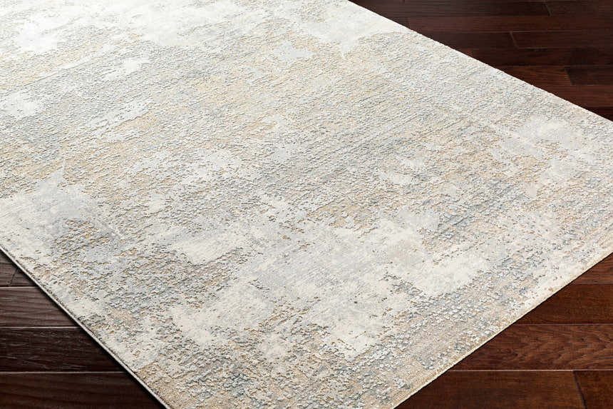 Close-up of the Adwoa Boutique Rug showing its contemporary cloud gray, nutmeg, and gray abstract pattern. Corner