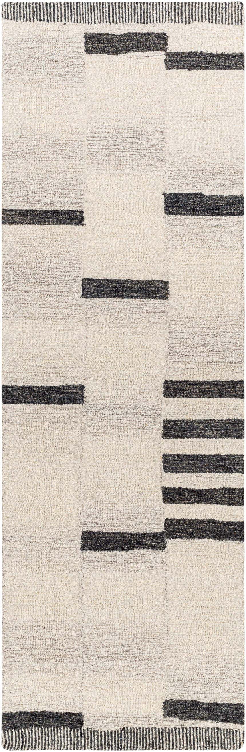 Close-up of the Aibonito Rug. Hand-tufted wool rug with a geometric pattern in beige and black. Contemporary style. Design-Runner-268