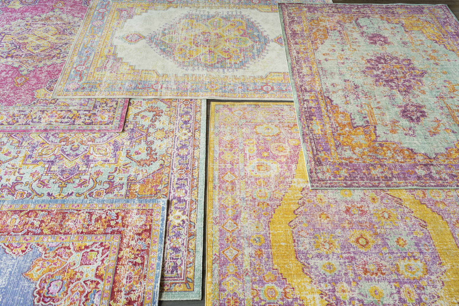 Close-up of Grelton Area Rugs in burgundy, lavender, mustard, purple, saffron, sage, seafoam, white, and yellow. Bohemian style. Styleshot