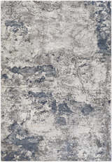 Close-up of the Ainslie Gray Marble Rug, showing its charcoal, navy, and white abstract pattern. Design-Rectangle-5376