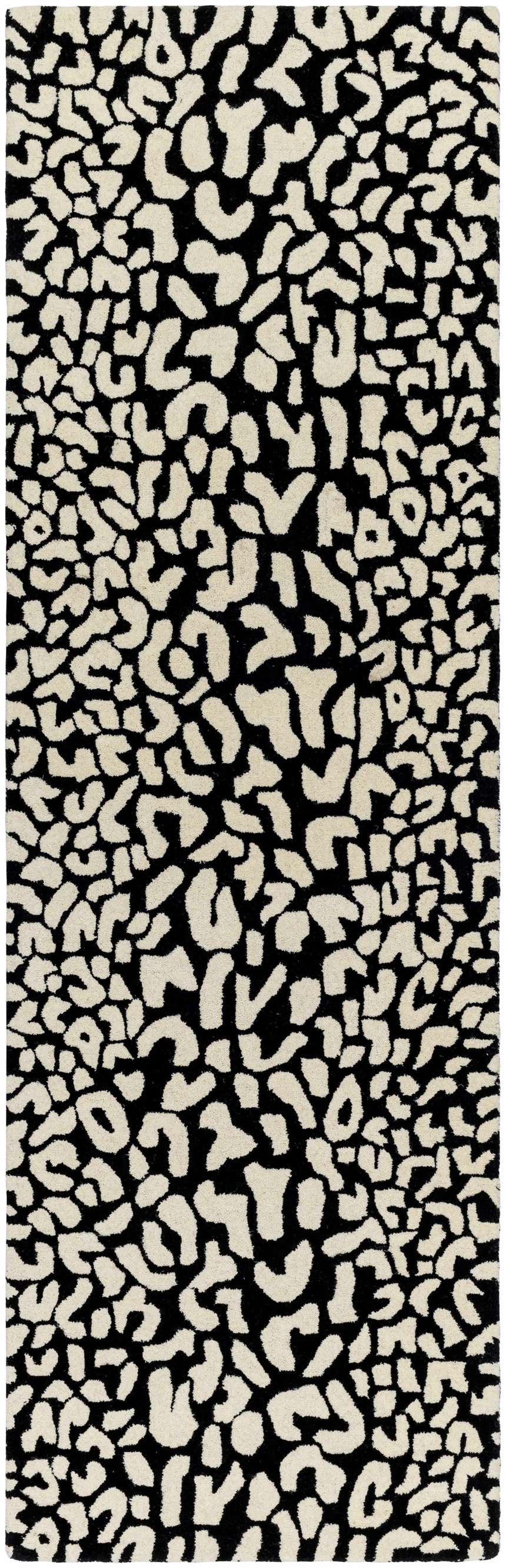 Close-up of the Akeem Leopard Print Area Rug. Beige wool spots on a dark gray background create a contemporary animal print. Design-Runner-268
