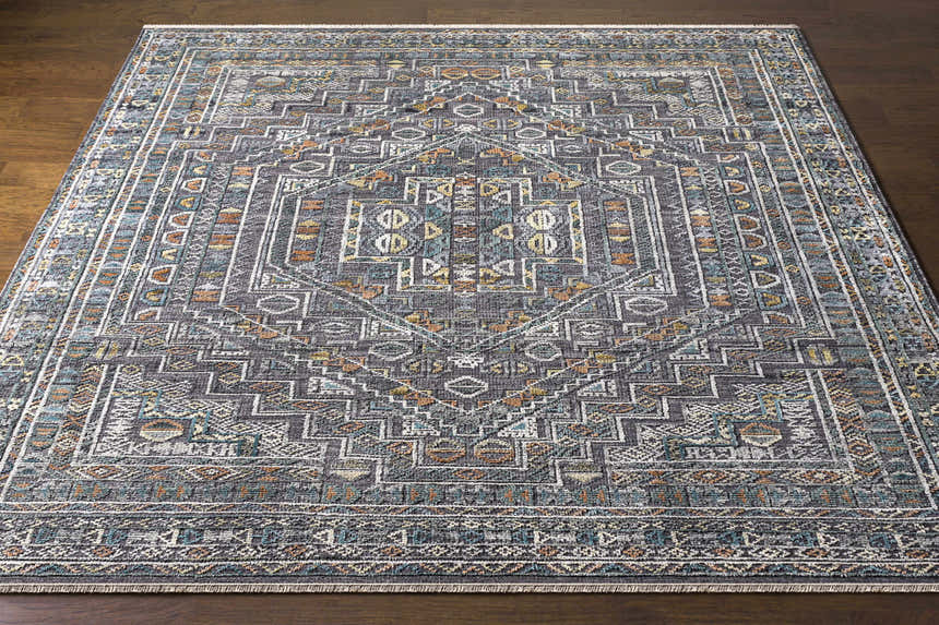 Close-up of Akle Premium Hand Knotted Wool Area Rug. Charcoal, cream, blue, peach tones, traditional geometric design. Front