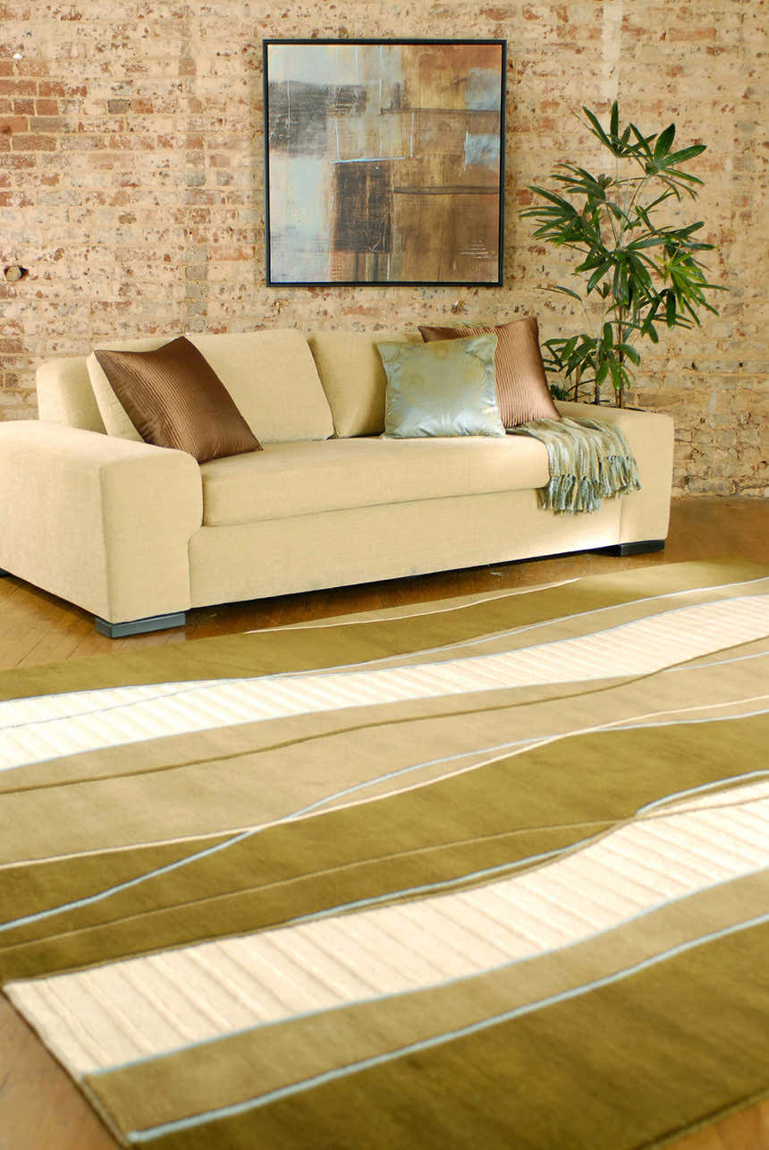 Living room scene with a tan sofa and the Alanreed Brown Premium Wool Area Rug in dark brown and sage. Roomscene-Rectangle