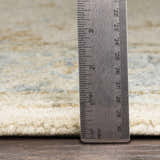 Close-up of the Albert Luxury Wool Rug pile height, showing beige, charcoal, and pale blue tones. Hand-tufted texture visible. Pile