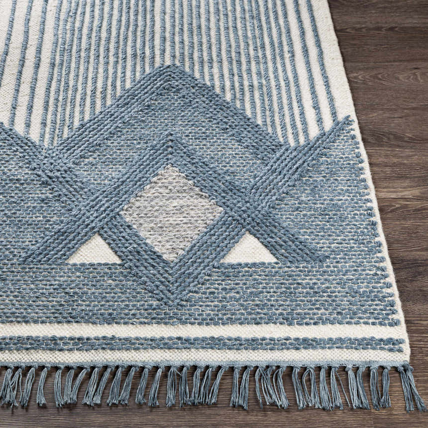 Close-up of the hand woven Aldbourne Blue Tassel Flatweave Wool Rug, featuring geometric designs and fringe detail. Front