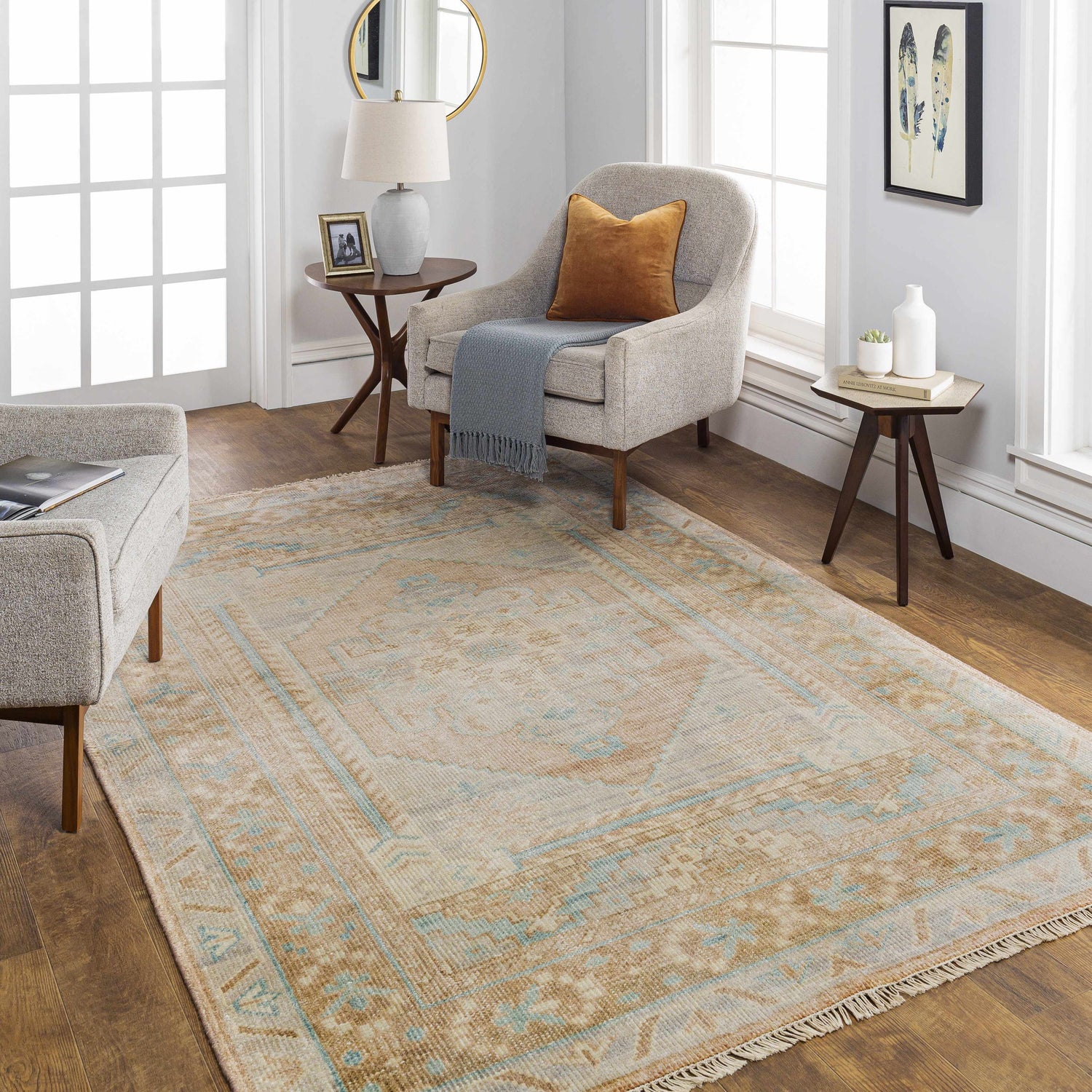 Living room scene with a tan and blue Aliang Premium Rug, neutral furniture, and wood floors. Roomscene-Rectangle