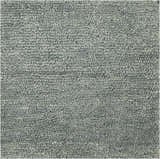 Close-up of the sage Ammanford Area Carpet. Hand-woven wool rug with a dense, textured pile. Texture