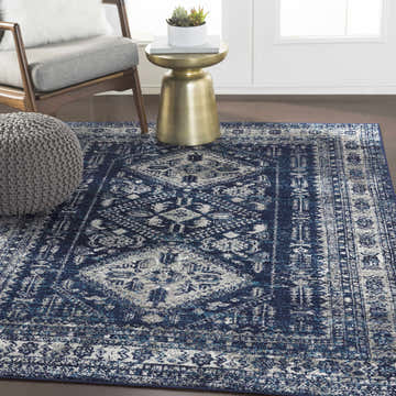Living room scene with a blue and light gray Andes Blue Area Rug, gray chair, and gold side table. Roomscene-Rectangle