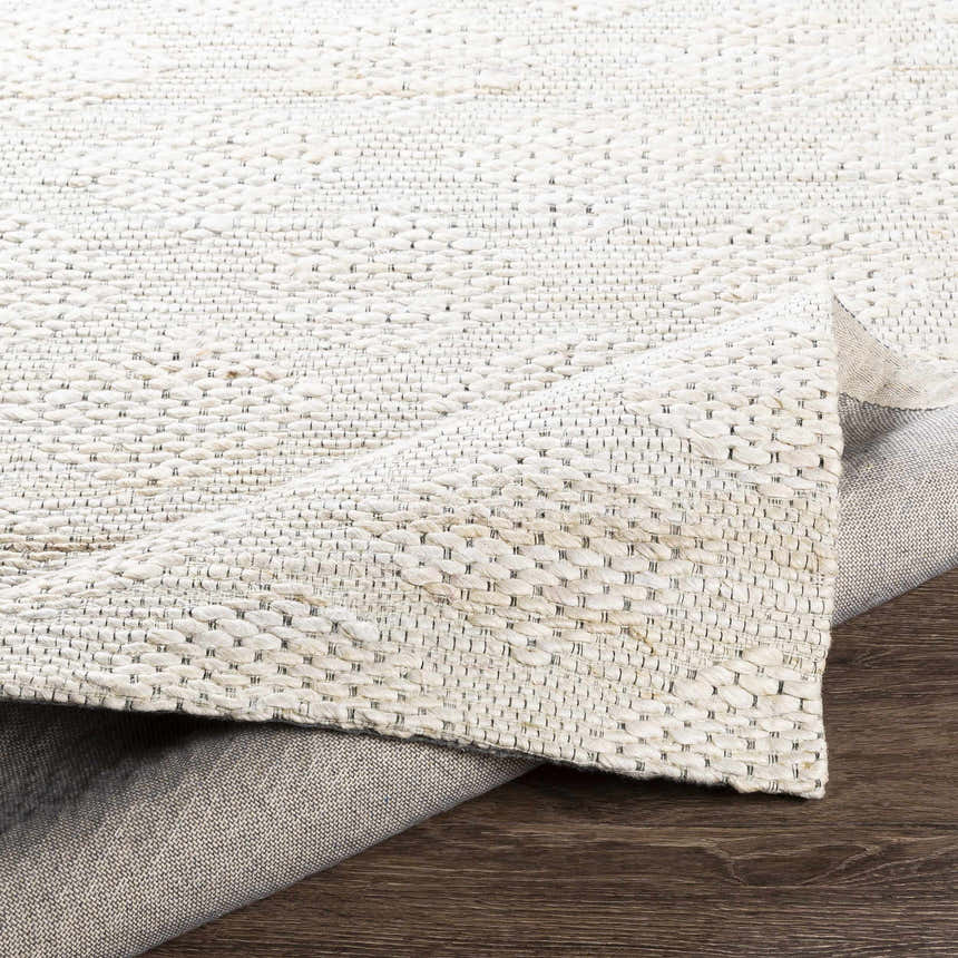 Close up of the hand-woven texture of the Angaston Beige Jute Rug, showing the backing and detail. Fold