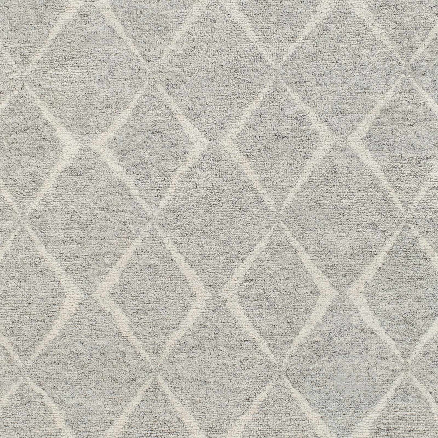 Close-up of Anito Premium Rug in charcoal and gray with a subtle diamond pattern. Hand-knotted wool and viscose texture. Swatch