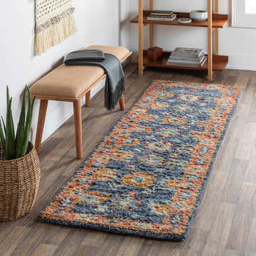 Hallway scene with Ankara Premium Wool Area Rug. Bohemian style runner rug in aqua, orange, and blue. Bench, plant, and bookshelf complete the look. Roomscene-Runner