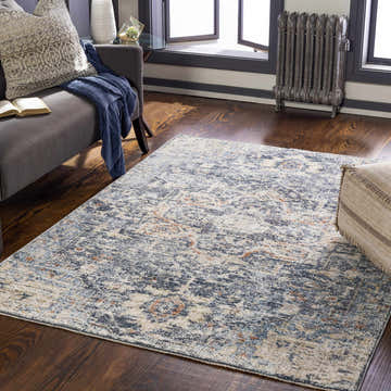 Cozy living room with an Aramayuan Area Rug in brick red, cream, denim, and gray. Sofa with throw and book. Roomscene-Rectangle