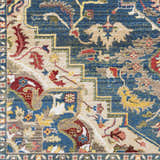 Close up of the Argyle Area Rug, showing a traditional oriental pattern in blue, red, tan, and yellow. Swatch