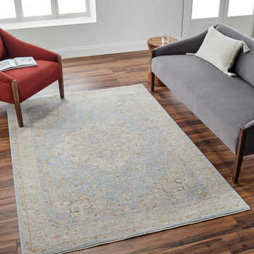 Living room scene with a gray sofa, red chair, and Arjun Thick Luxe Area Rug in amber, olive, and gray tones. Roomscene-Rectangle