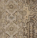 Close-up of the Arlington Area Carpet, a hand-knotted wool rug in beige, charcoal, and denim with a traditional pattern. Swatch