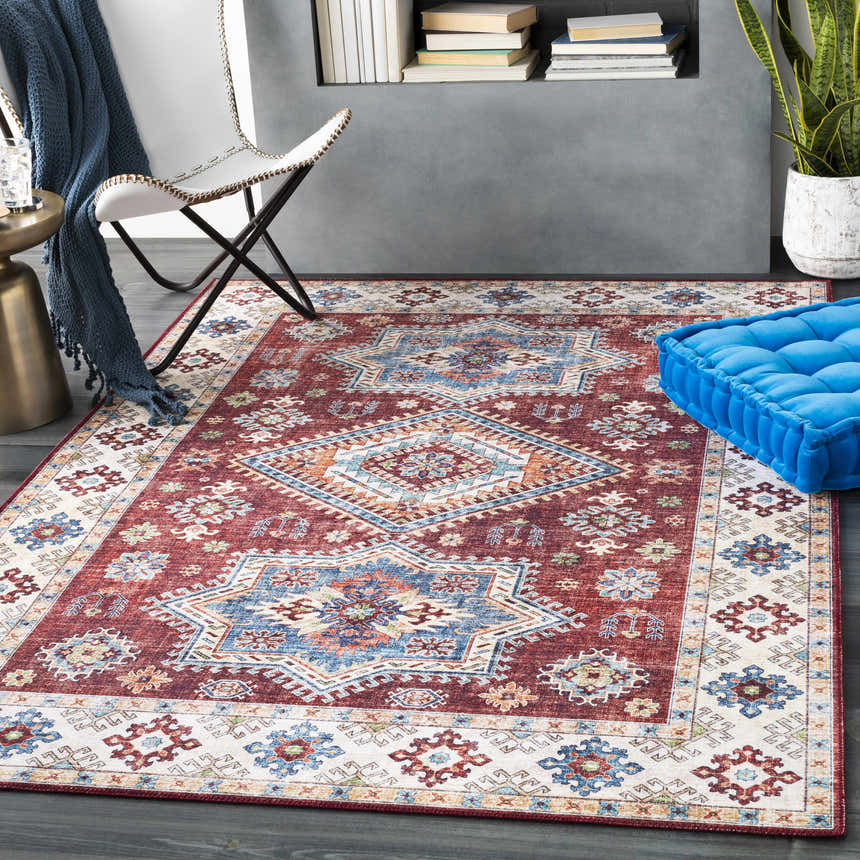 Styled living room featuring the Armadale Clearance Rug with a bohemian, Southwestern design in red, blue, and cream. Roomscene-Rectangle