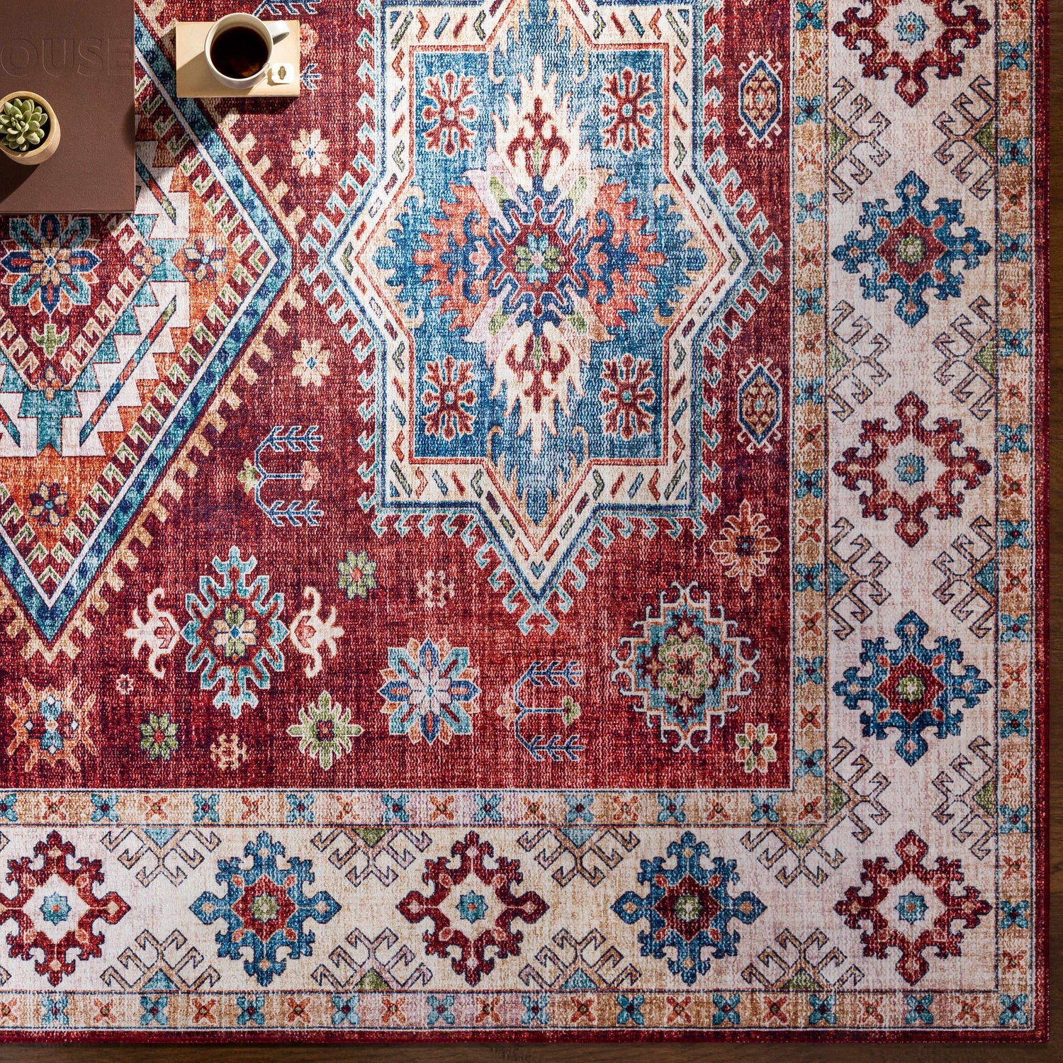 Close-up of the Armadale Clearance Rug, showcasing its bohemian-inspired red, blue, and cream geometric pattern. Styleshot