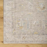 Close-up of the Ashra Thick Luxe Area Rug showing its traditional pattern, cloud gray, and light brown colors. Corner