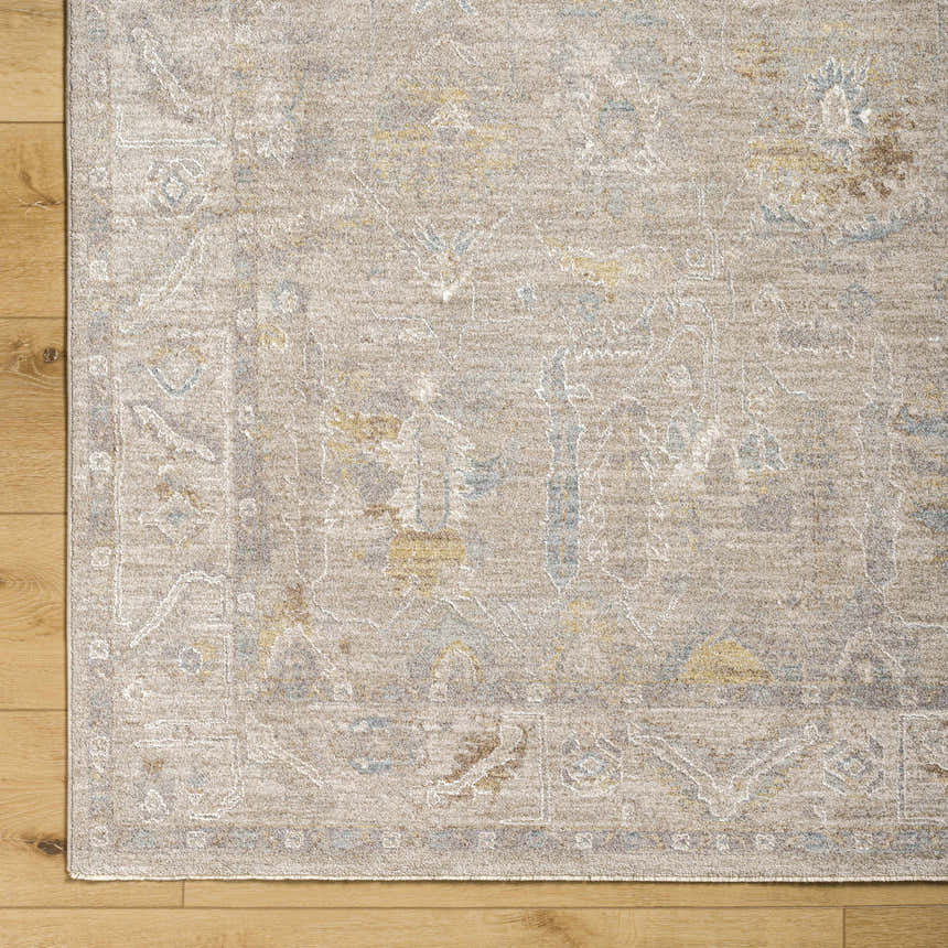 Close-up of the Ashra Thick Luxe Area Rug showing its traditional pattern, cloud gray, and light brown colors. Corner