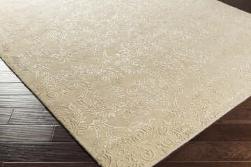 Close-up of the taupe Aubrey Area Rug showing its traditional floral design and hand-knotted texture. Corner