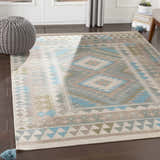 Living room scene with the Auchterarder Carpet, a wool rug in aqua, blue, and brown with a geometric pattern. Roomscene-Rectangle