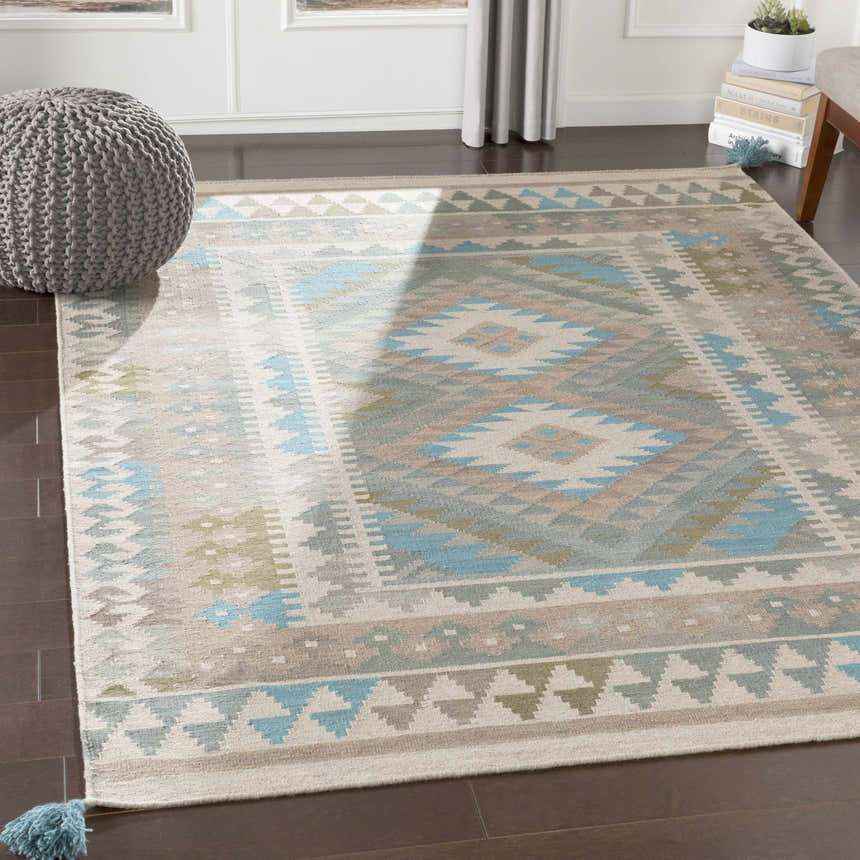 Living room scene with the Auchterarder Carpet, a wool rug in aqua, blue, and brown with a geometric pattern. Roomscene-Rectangle