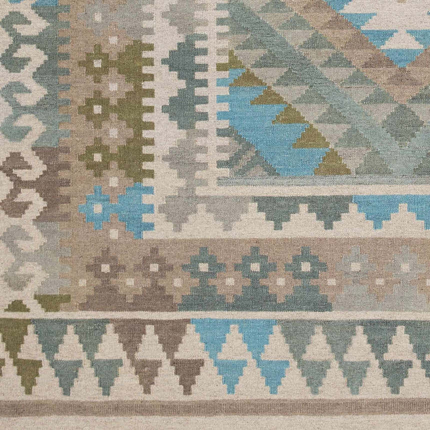 Close-up of the Auchterarder Carpet, a hand-woven wool rug with aqua, blue, sage, and brown geometric patterns. Swatch