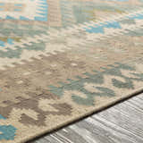 Close-up of Auchterarder Carpet, a hand-woven wool rug with a farmhouse design in aqua, sage, tan, and brown hues. Texture