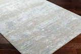 Close-up of the Avani Thick Luxe Boutique Rug showing its gray, light gray, and nutmeg abstract pattern. Corner