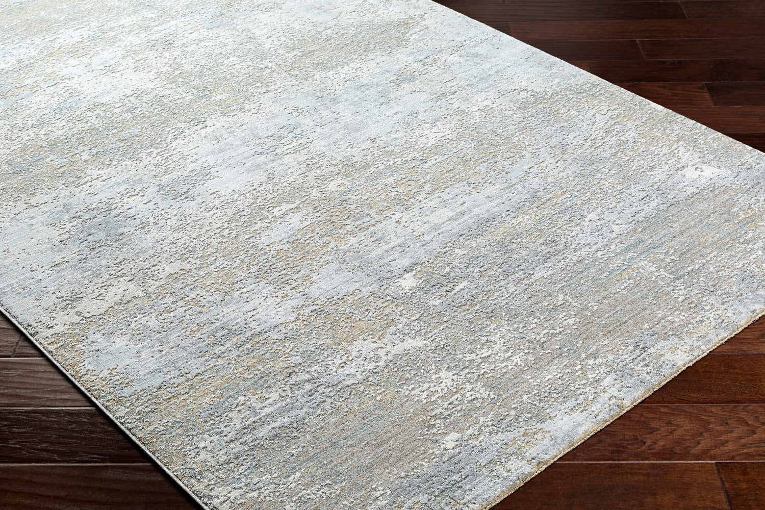 Close-up of the Avani Thick Luxe Boutique Rug showing its gray, light gray, and nutmeg abstract pattern. Corner