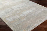 Close-up of the Avani Thick Luxe Boutique Rug, showcasing its gray, nutmeg, and white contemporary design and textured weave. Corner