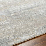 Close-up of the Avani Thick Luxe Boutique Rug showing its gray, white, and nutmeg abstract pattern and plush texture. Texture