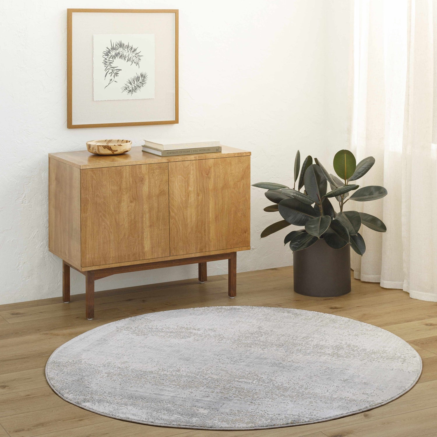 Entryway with light wood floors, cabinet, and round Avani Thick Luxe Boutique Rug in gray tones. Roomscene-Round