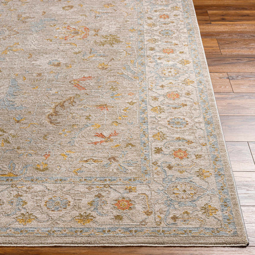 Close-up of the Awena Thick Luxe Area Rug showing its traditional floral pattern and amber, brown, and blue colors. Front