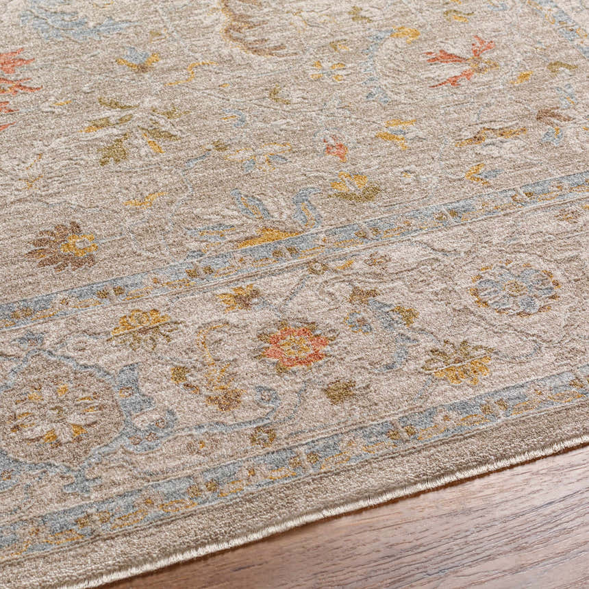 Close-up of the Awena Thick Luxe Area Rug. Traditional floral pattern in amber, dusty pink, and light olive on a taupe background. Texture
