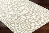 Close-up of the Azuka Leopard Print Area Rug, showing beige and gray animal print pattern and wool texture. Corner