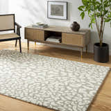 Living room scene with beige Azuka Leopard Print Area Rug, wood floors, console table, chair, and potted plant. Roomscene-Rectangle