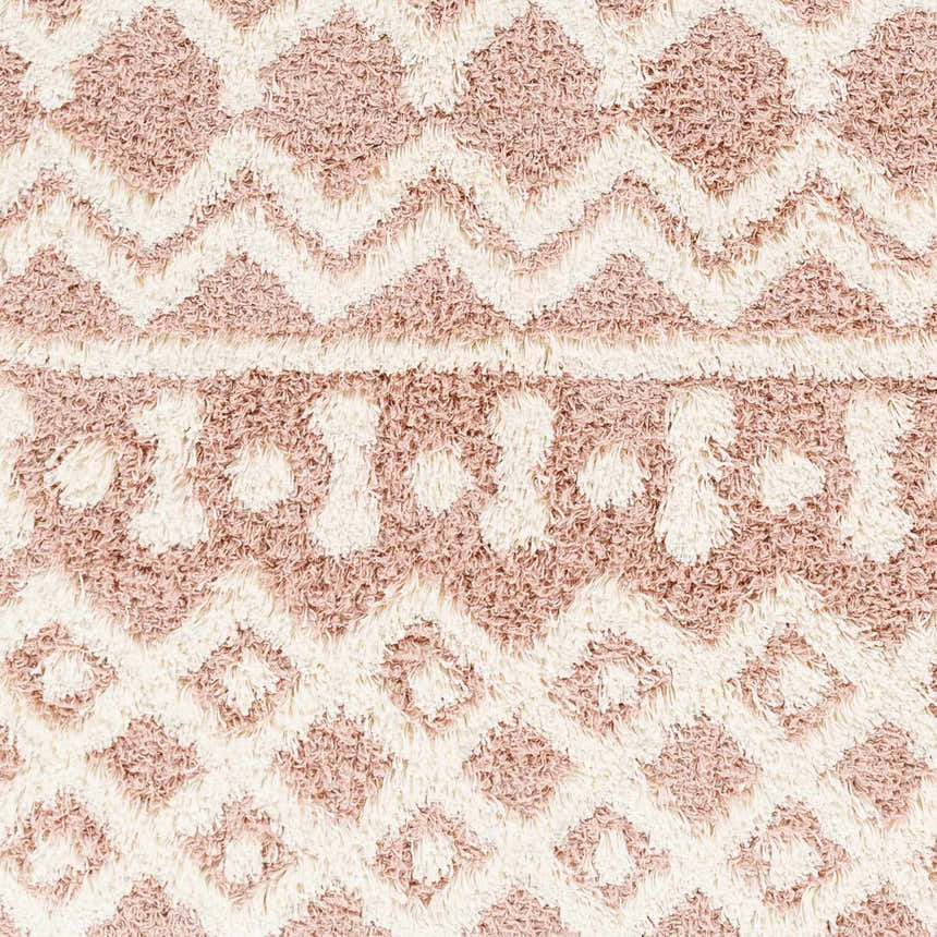 Close-up of the Azura Shag Area Rug showing its geometric pattern, shag texture, and colors: dusty pink, white thatch, and dark beige. Swatch
