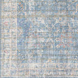 Close-up of the Bagontapay Washable Area Rug. Features a blue, cream, and light brown traditional floral pattern. Swatch