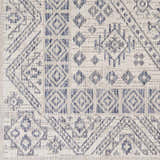Close-up of the Balarim Indoor & Outdoor Rug, showcasing its geometric diamond pattern in charcoal and light gray. Swatch