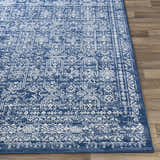 Close-up of the Michie Dark Blue Area Rug showing its intricate white, light blue, and dark blue bohemian pattern. Front