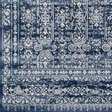 Close-up of the Michie Dark Blue Area Rug showing its detailed bohemian-style white and dark blue pattern. Swatch