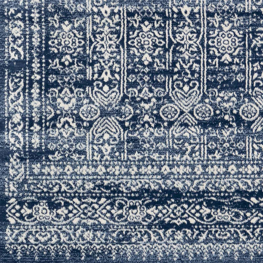 Close-up of the Michie Dark Blue Area Rug showing its detailed bohemian-style white and dark blue pattern. Swatch