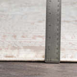 Close up of Terlingua Blush Greek Mosaic Carpet showing the rug's texture, pile height, and blush, tan, and brown colors. Pile