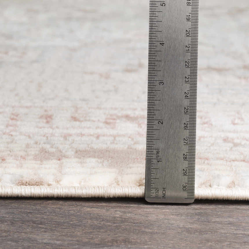 Close up of Terlingua Blush Greek Mosaic Carpet showing the rug's texture, pile height, and blush, tan, and brown colors. Pile