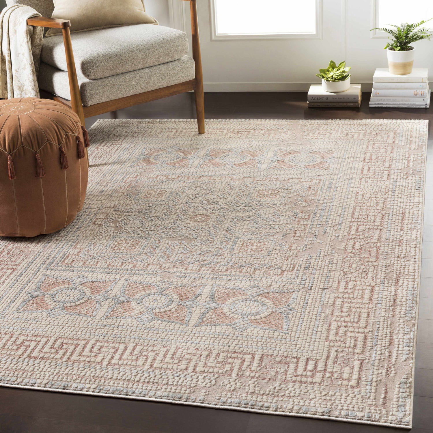 Living room with the Terlingua Blush Greek Mosaic Carpet, tan chair, and brown pouf. Bohemian style. Styleshot