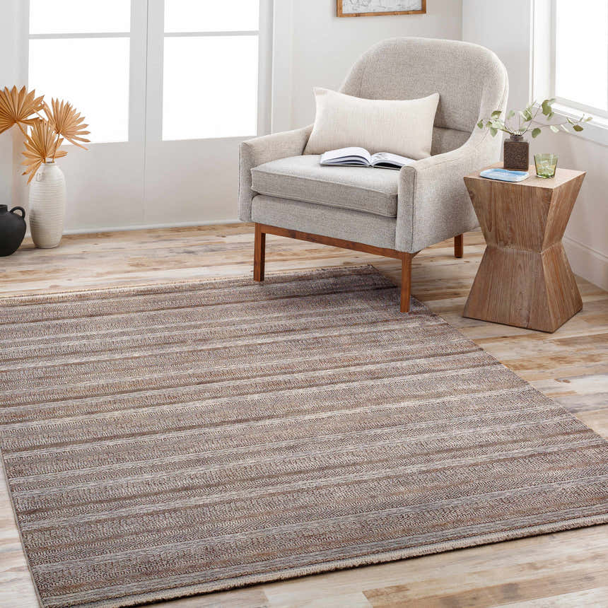 Living room scene with a gray chair and Batarasa Area Carpet in charcoal, light gray, and medium gray. Roomscene-Rectangle